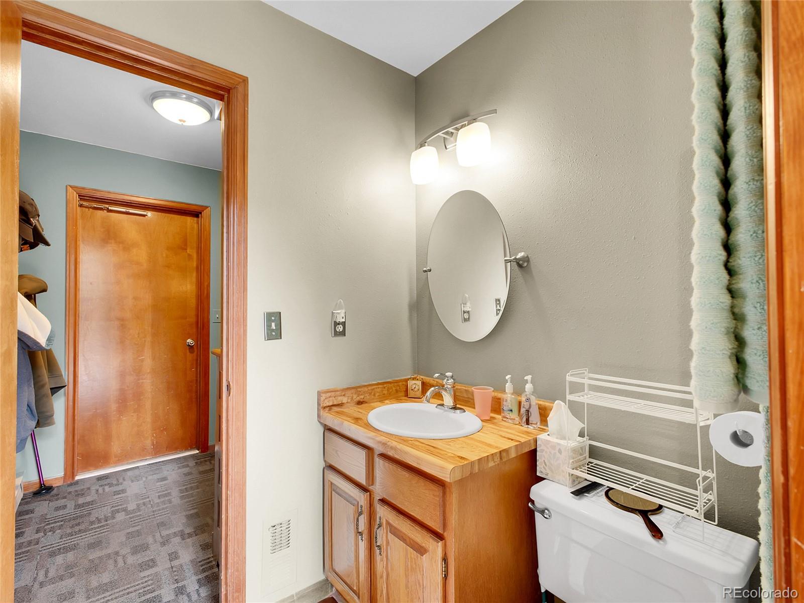 29752 Bearcat Trail Conifer, CO 80433 - Photo 23 of 50 a bathroom with a sink and a mirror