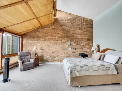 a bedroom with a bed and a couch