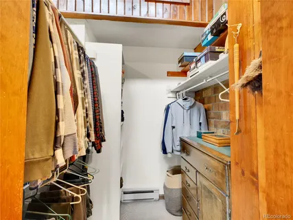 a view of walk in closet with clothes and shoes
