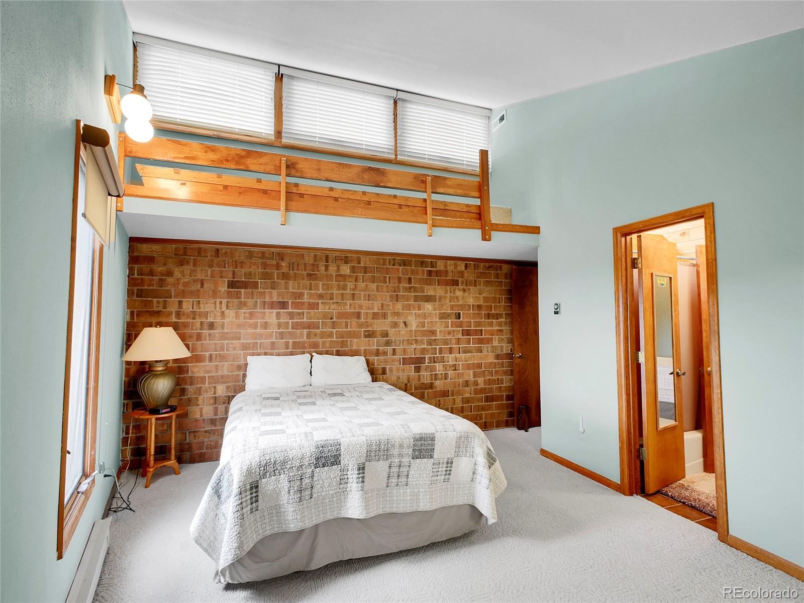 29752 Bearcat Trail Conifer, CO 80433 - Photo 36 of 50 a bedroom with a bed and a dresser