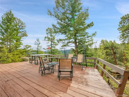 a deck view with a table and chairs and wooden floor