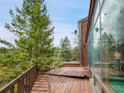 a view of balcony with wooden floor and fence
