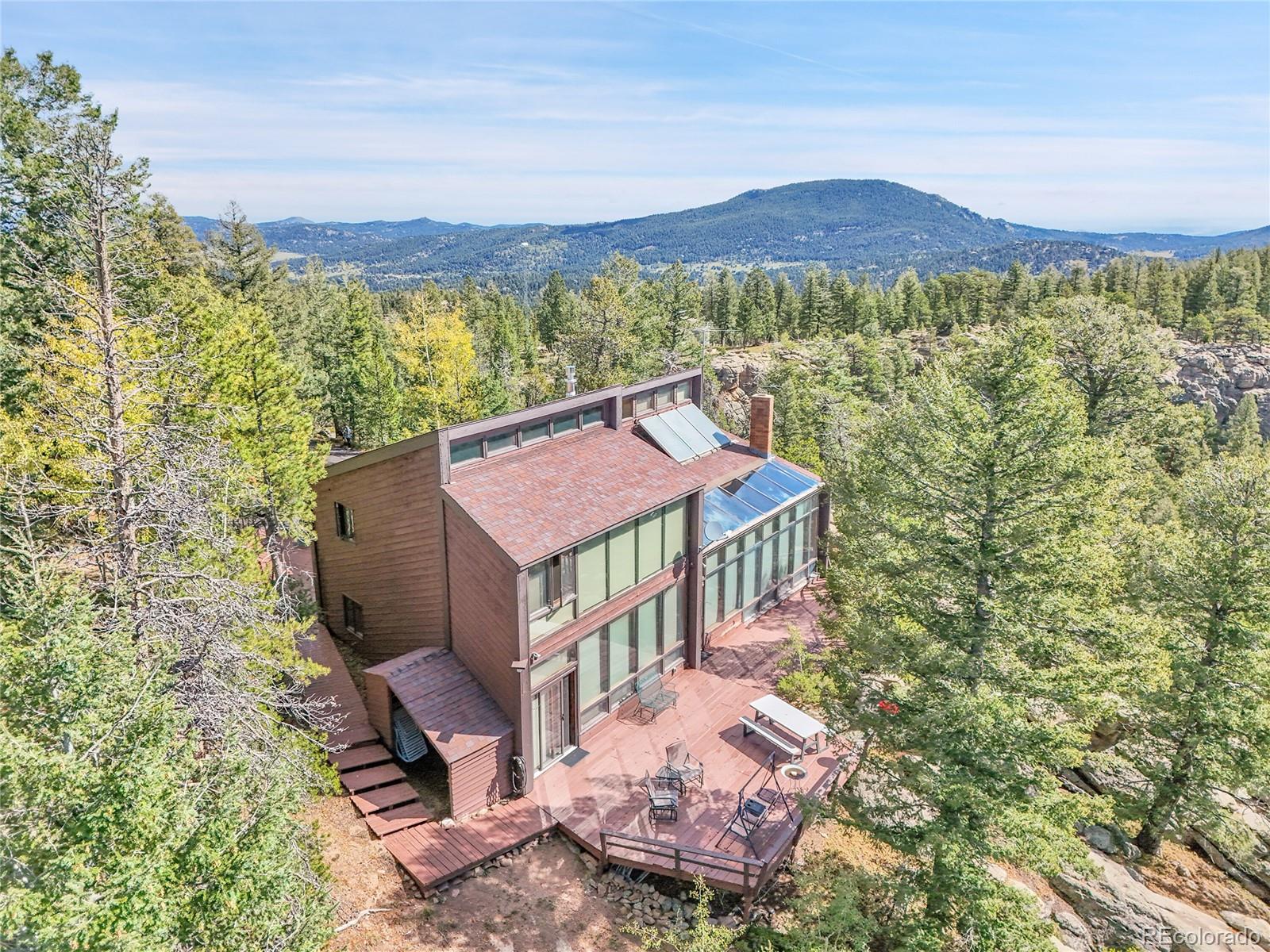 29752 Bearcat Trail Conifer, CO 80433 - Photo 47 of 50 a view of a house with a yard