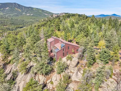 a view of a lush green field with mountains in the background