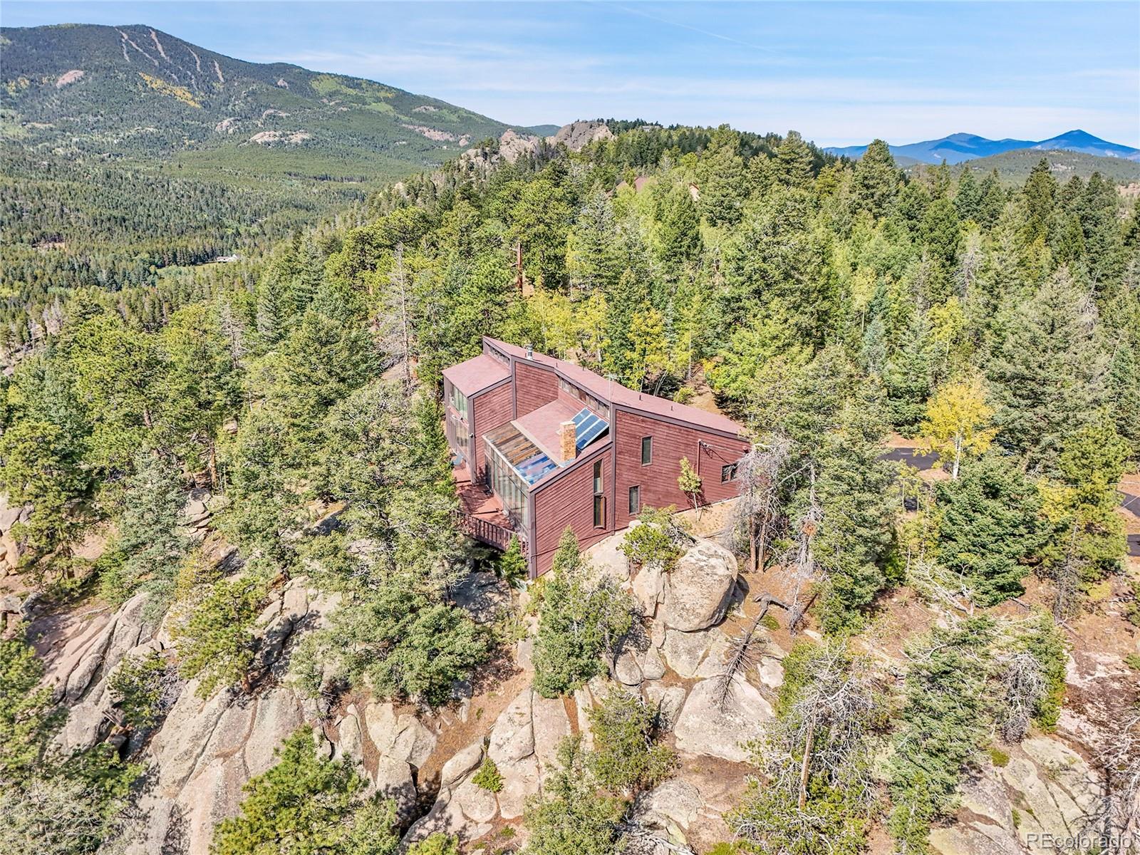 29752 Bearcat Trail Conifer, CO 80433 - Photo 49 of 50 a view of a lush green field with mountains in the background