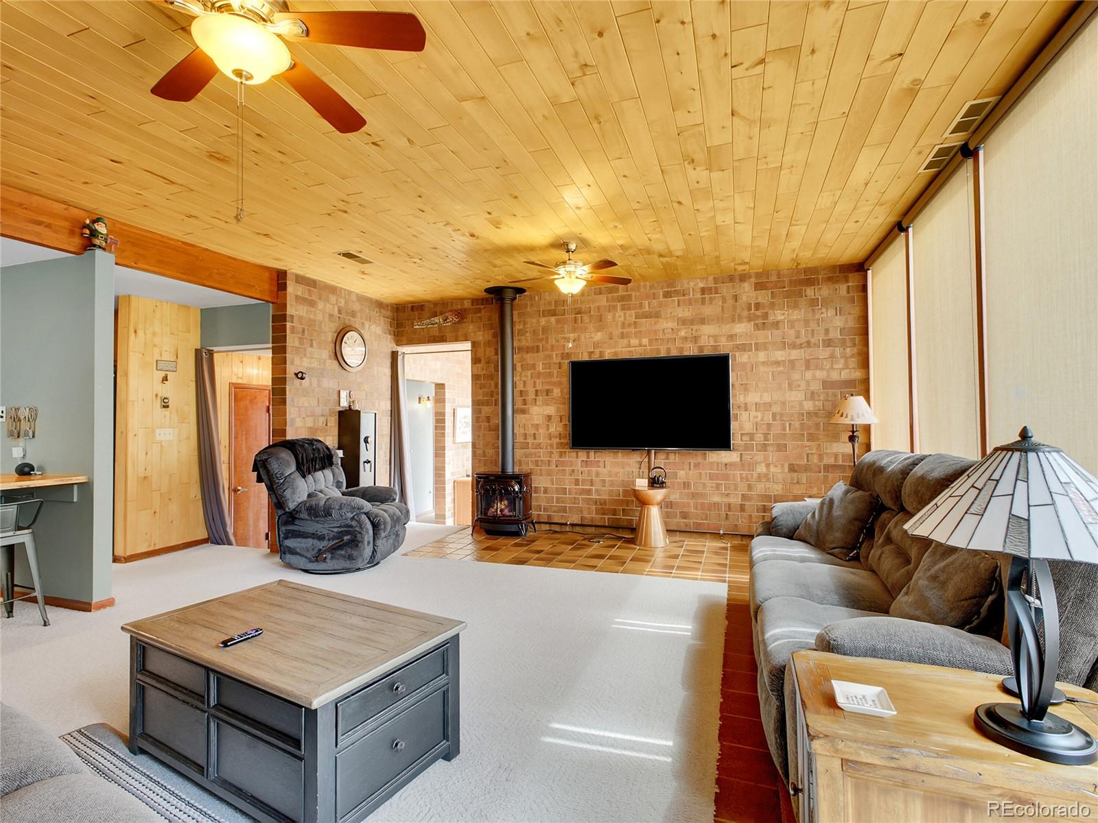 29752 Bearcat Trail Conifer, CO 80433 - Photo 9 of 50 a living room with furniture and a flat screen tv