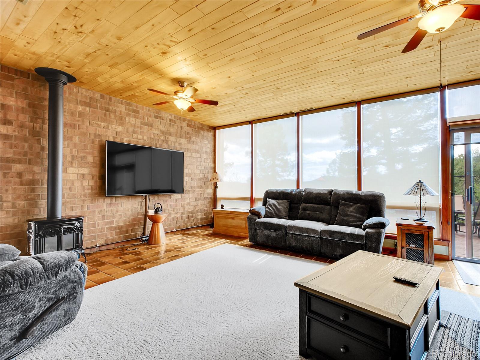 29752 Bearcat Trail Conifer, CO 80433 - Photo 10 of 50 a living room with furniture and a flat screen tv