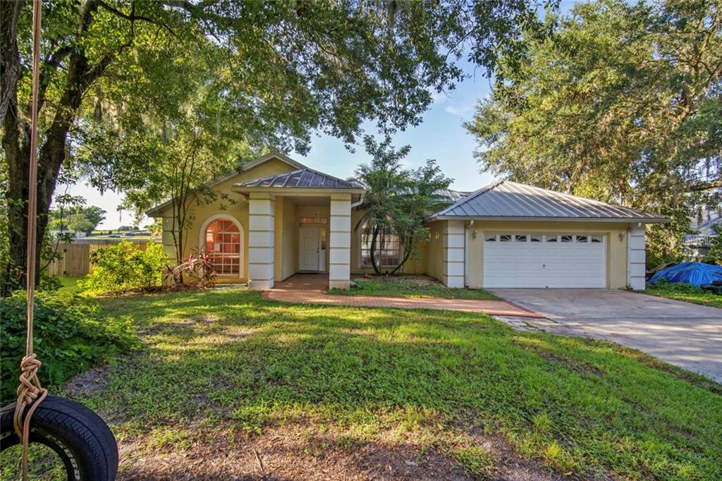 13017 Sydney Road Dover, FL 33527 - Photo 1 of 1 a front view of a house with garden