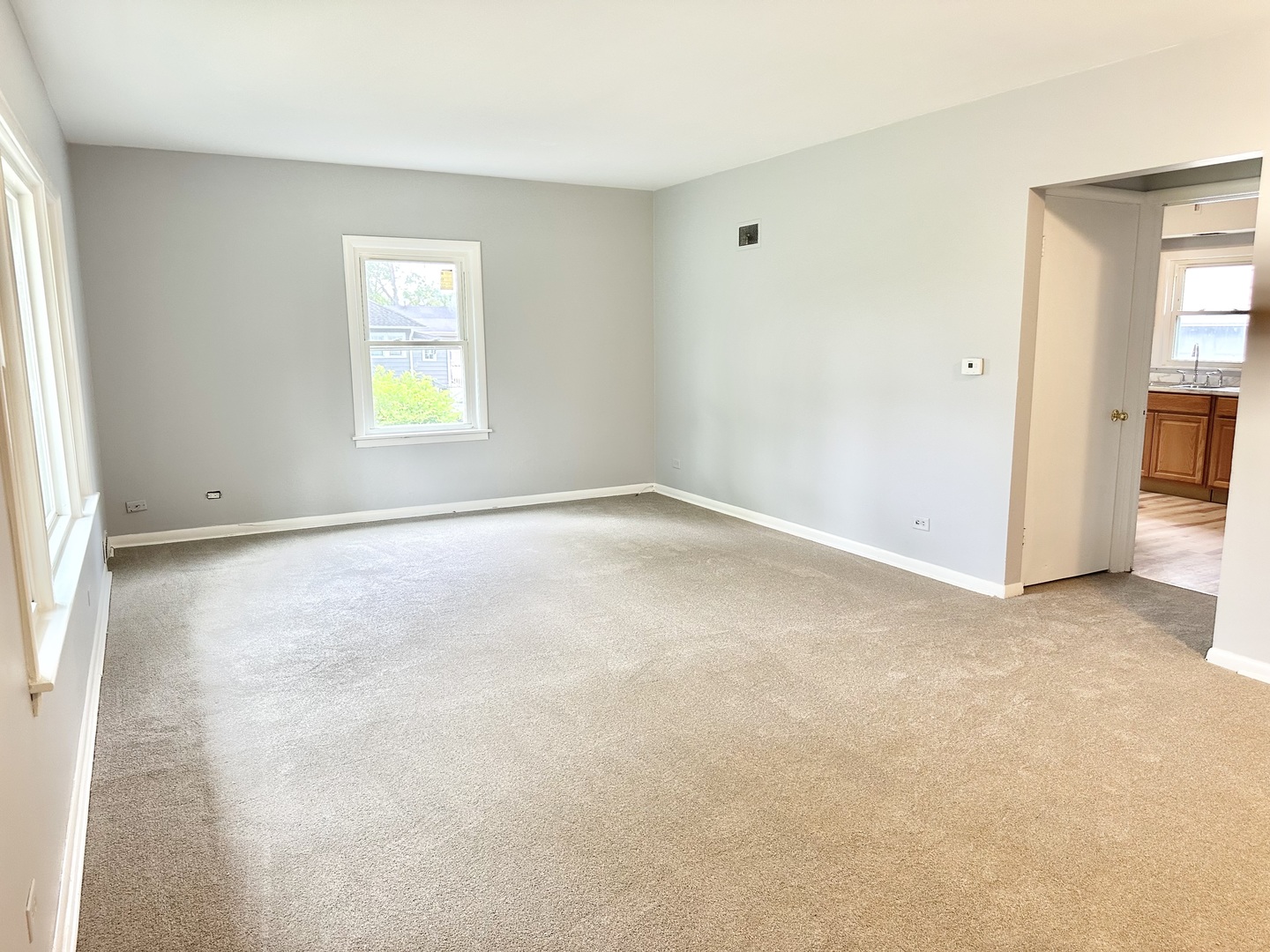 301 Illinois Avenue Elgin, IL 60120 - Photo 4 of 14 an empty room with windows and closet