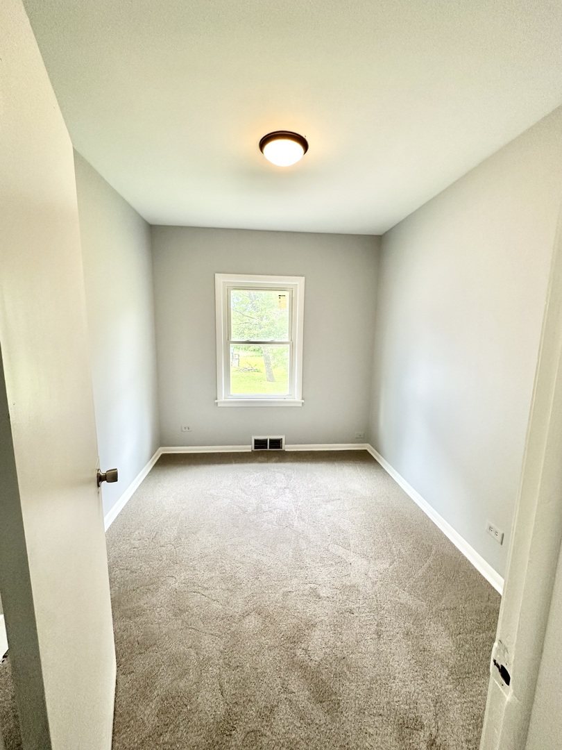 301 Illinois Avenue Elgin, IL 60120 - Photo 5 of 14 an empty room with a window
