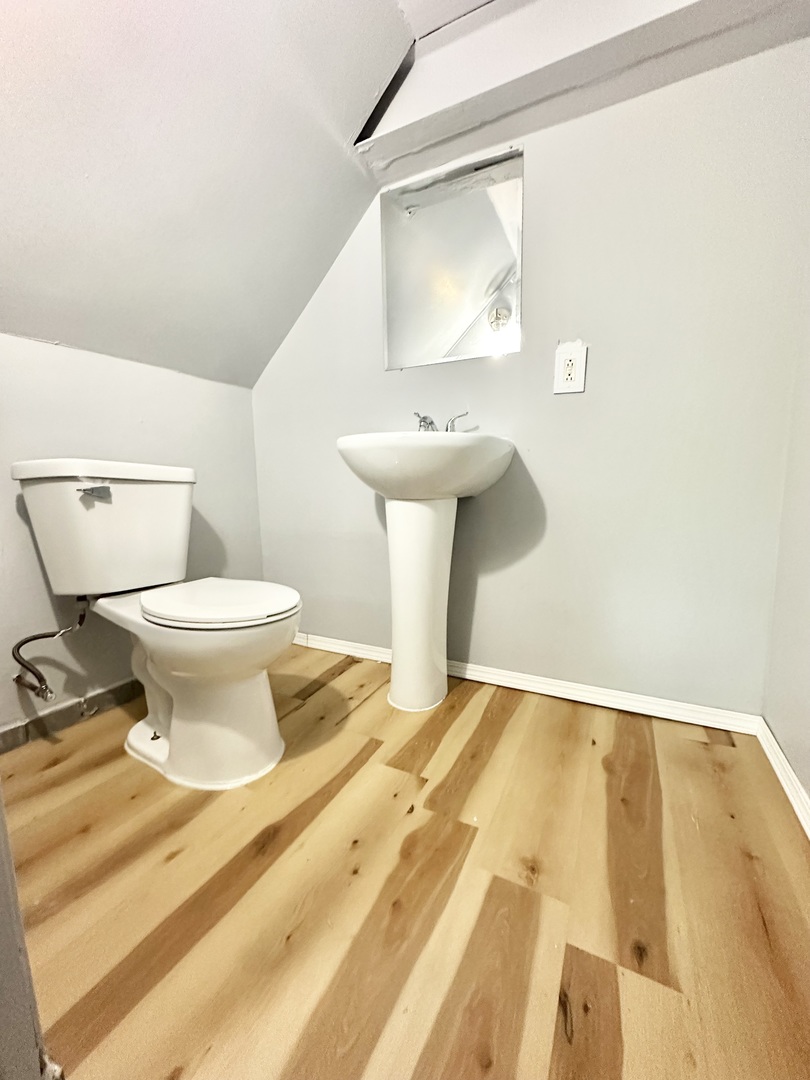 301 Illinois Avenue Elgin, IL 60120 - Photo 9 of 14 a bathroom with a sink toilet and a mirror