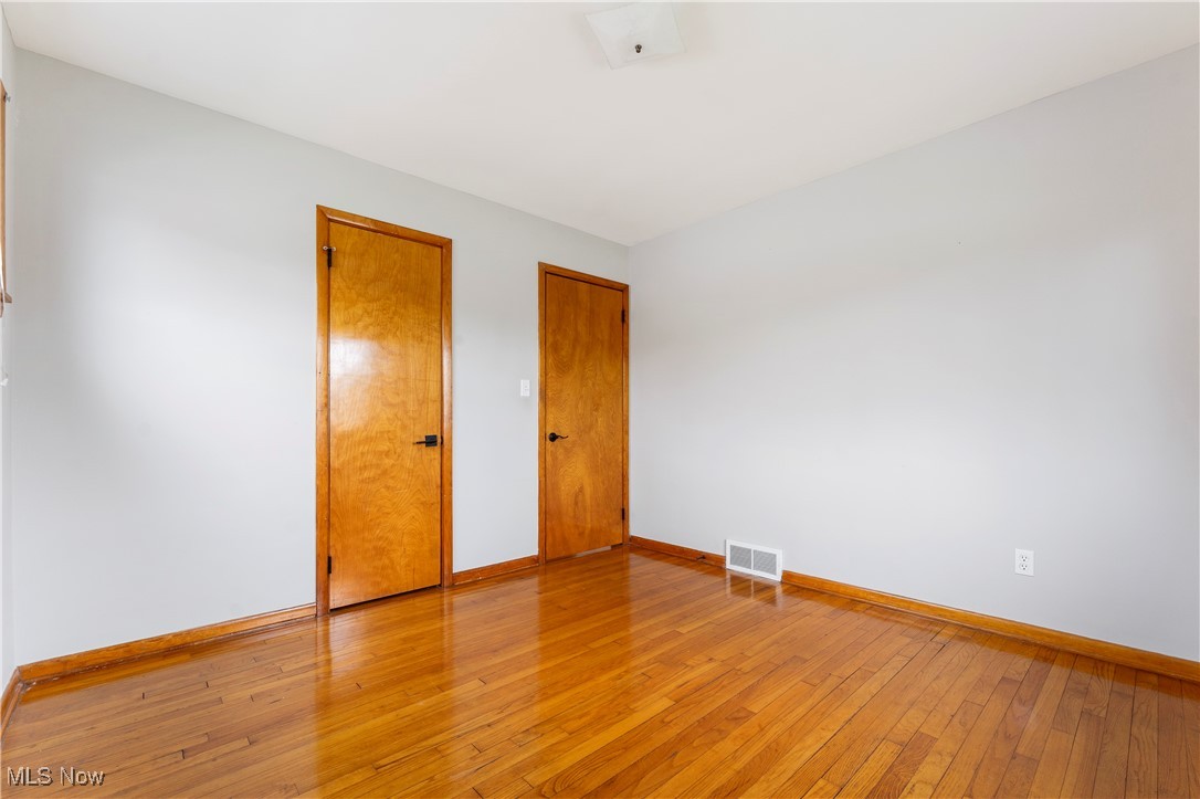 3105 Snow Road Cleveland, OH 44134 - Photo 13 of 38 Empty room with visible vents, baseboards, and light wood-style flooring