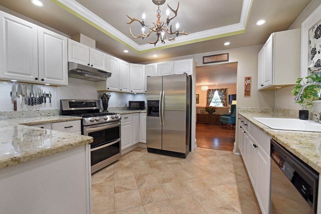 63 Loving Road Morganton, GA 30560 - Photo 24 of 58 a large kitchen with stainless steel appliances granite countertop a stove refrigerator and a sink