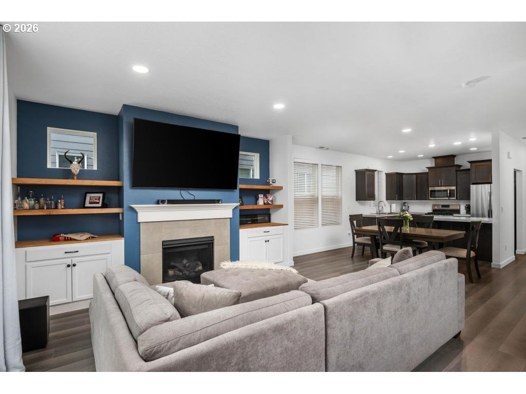 859 South 23rd Avenue Cornelius, OR 97113 - Photo 12 of 39 a living room with furniture a fireplace and a flat screen tv