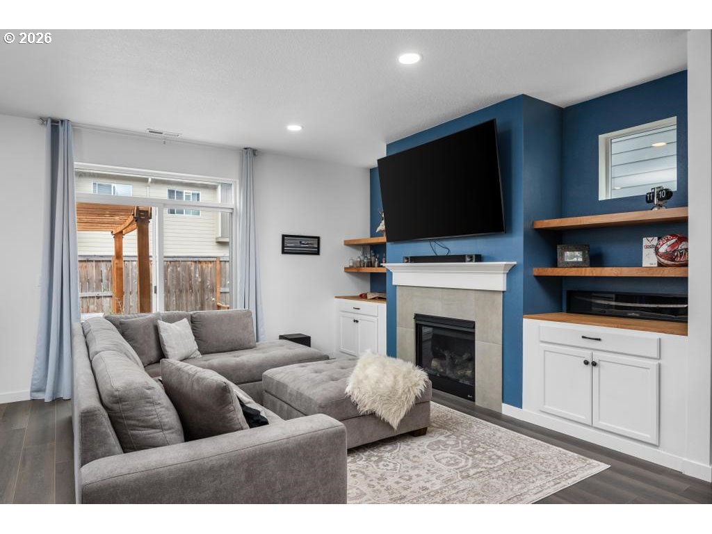 859 South 23rd Avenue Cornelius, OR 97113 - Photo 13 of 39 a living room with furniture a flat screen tv and a fireplace
