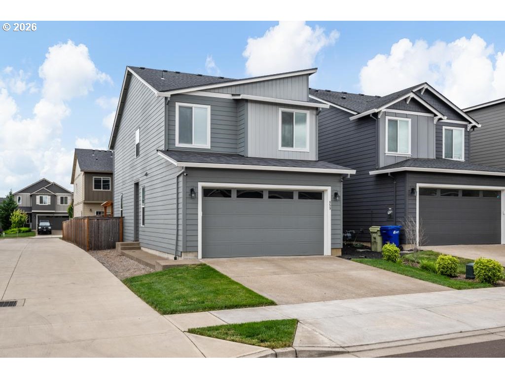859 South 23rd Avenue Cornelius, OR 97113 - Photo 2 of 39 a front view of a house with a yard and garage