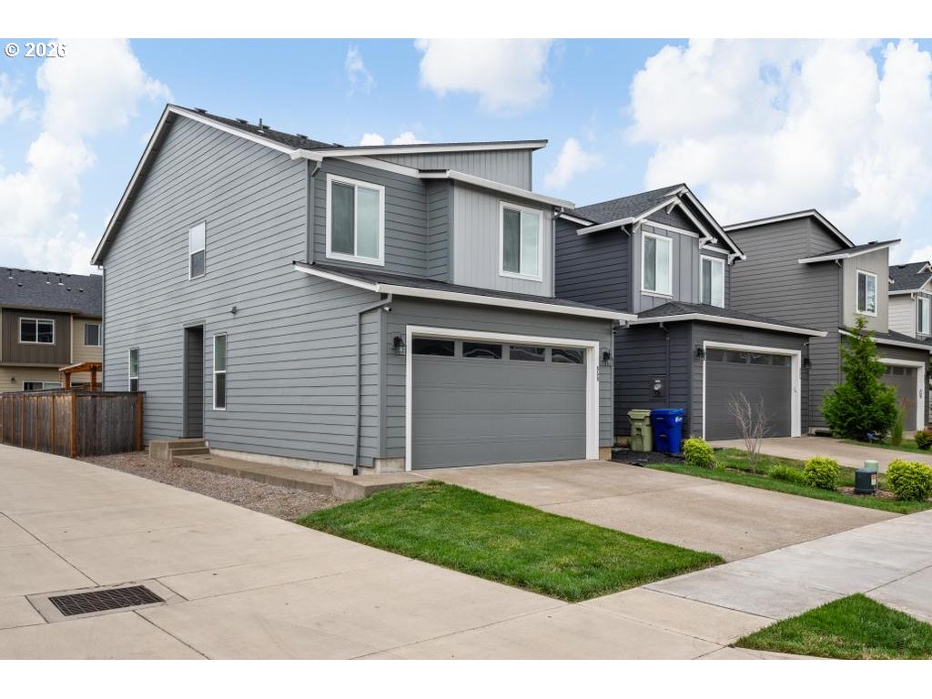 859 South 23rd Avenue Cornelius, OR 97113 - Photo 3 of 39 a front view of a house with a yard and garage