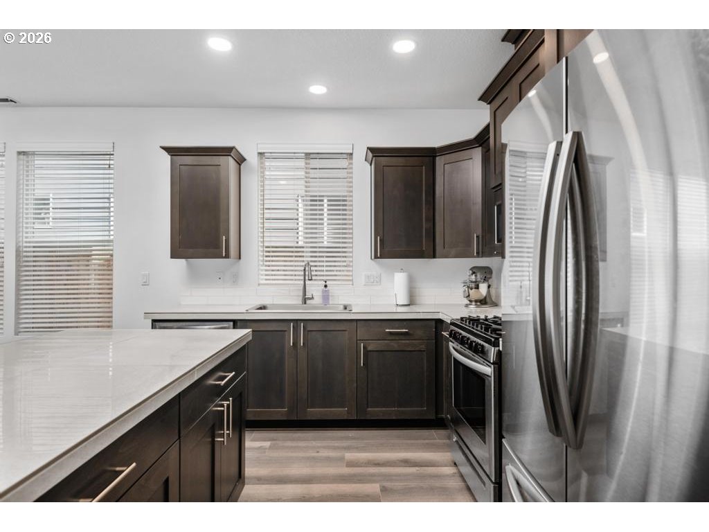 859 South 23rd Avenue Cornelius, OR 97113 - Photo 10 of 39 a kitchen with stainless steel appliances a sink stove and refrigerator