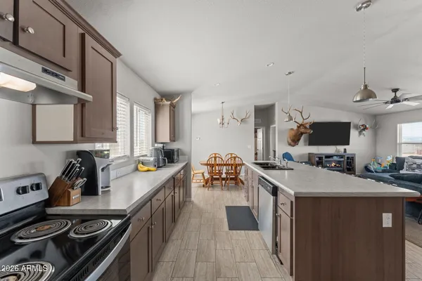 a kitchen with sink stove and cabinets