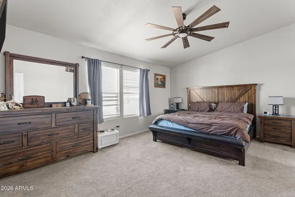 a spacious bedroom with a bed and window