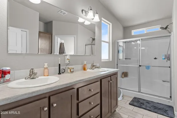 a bathroom with a sink double vanity and shower