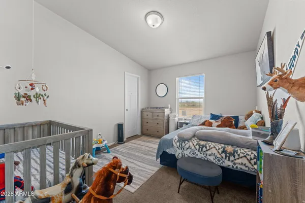 a bedroom with furniture and a window