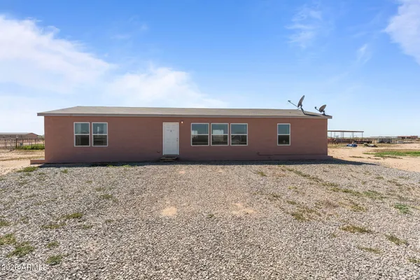 a view of house with yard and ocean view