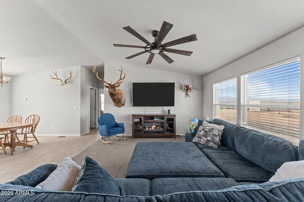 a living room with furniture and a flat screen tv with wooden floor