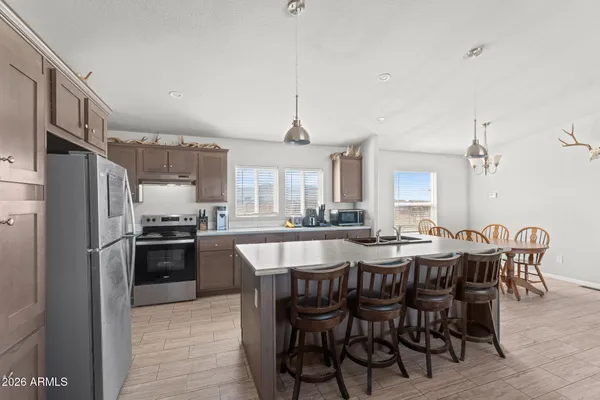 a large kitchen with a table and chairs