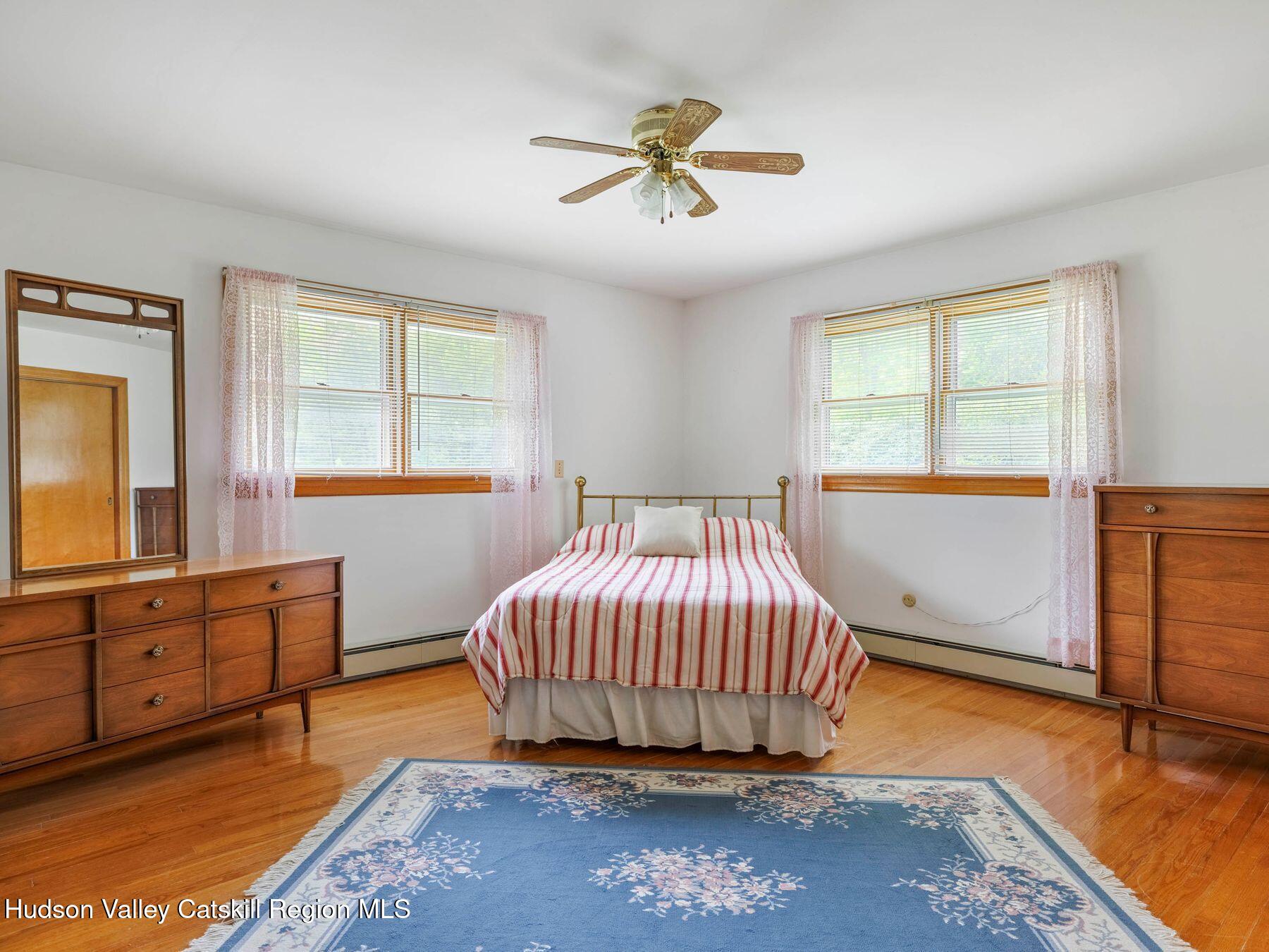 104 New Paltz Road Highland, NY 12528 - Photo 20 of 43 a living room with a bed and dresser with wooden floor