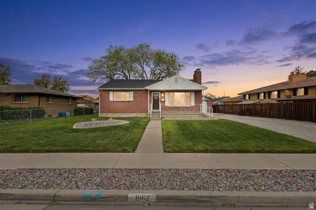 8162 Jackson Street Midvale, UT 84047 - Photo 1 of 1 Bungalow-style house with brick siding, a chimney, and a porch