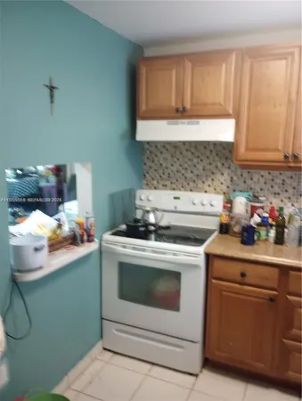 a kitchen with a stove and a cabinets