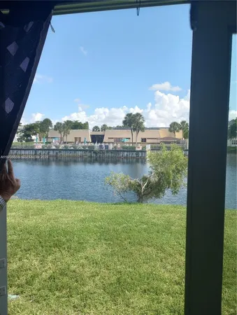 a view of a lake with houses in the back