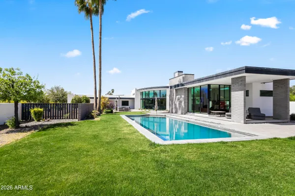 a view of a house with a swimming pool and a yard