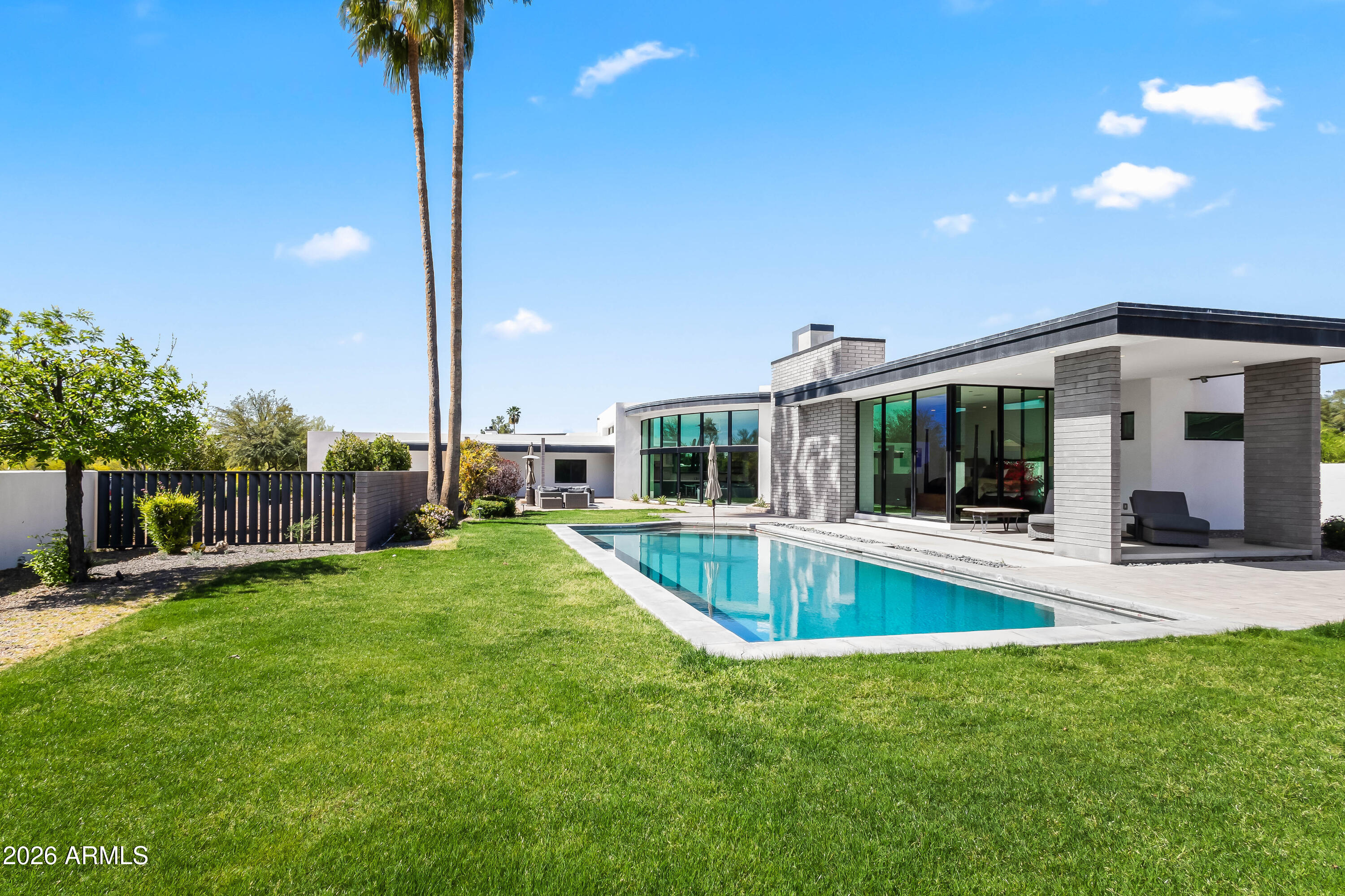 a view of a house with a swimming pool and a yard