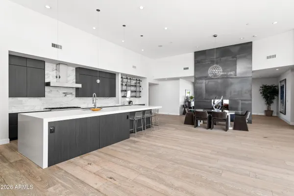 a living room with furniture a dining table and kitchen view