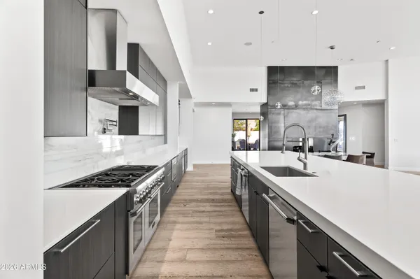 a kitchen with stainless steel appliances a sink stove and cabinets