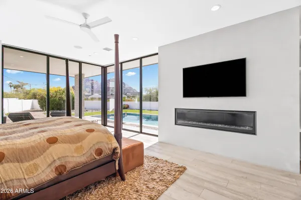 a bedroom with a bed and a flat screen tv