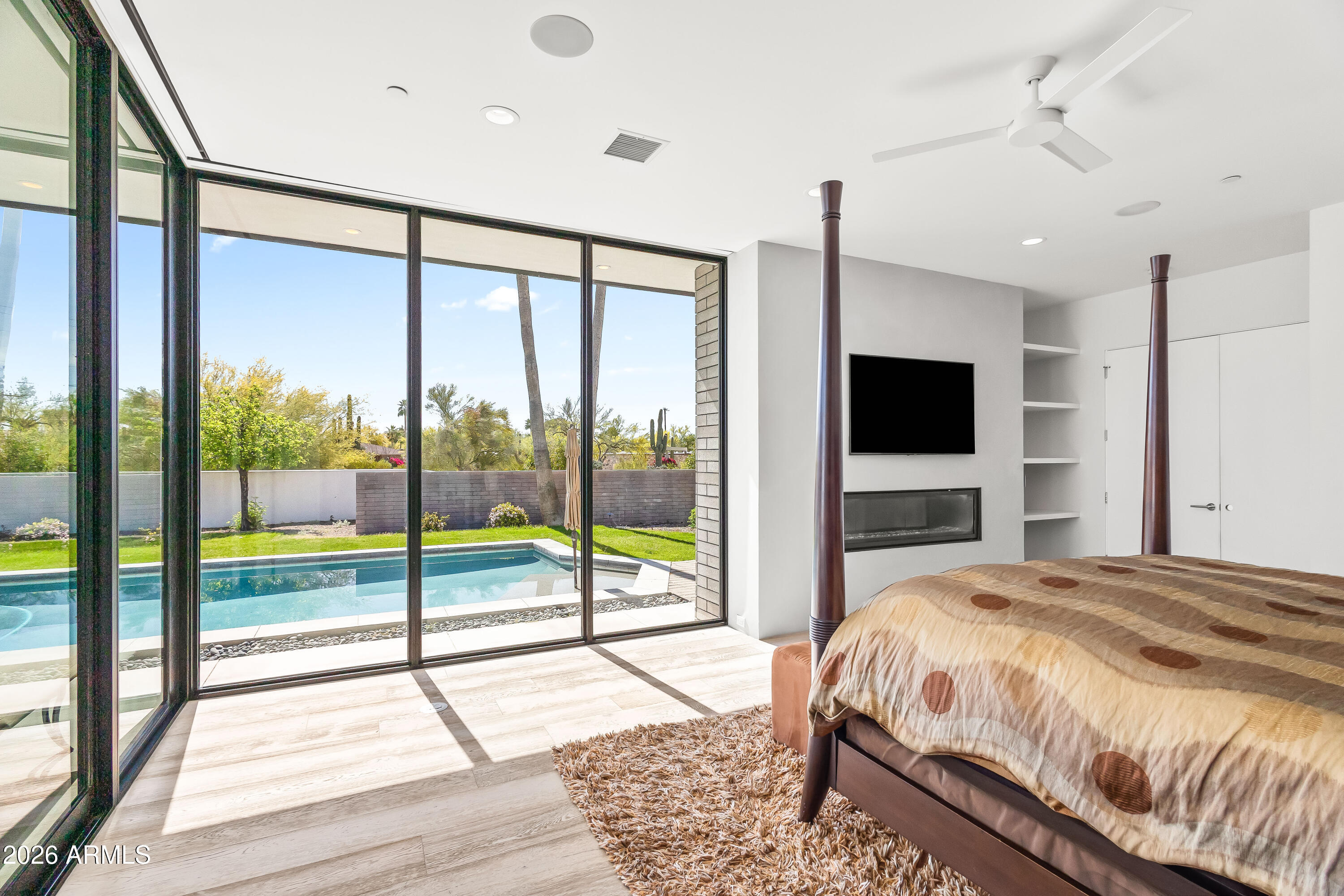 5430 North 41st Street Phoenix, AZ 85018 - Photo 15 of 38 a bedroom with a bed and a flat tv screen next to a window