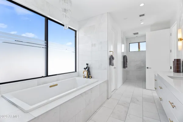 a bathroom with a bathtub and a sink