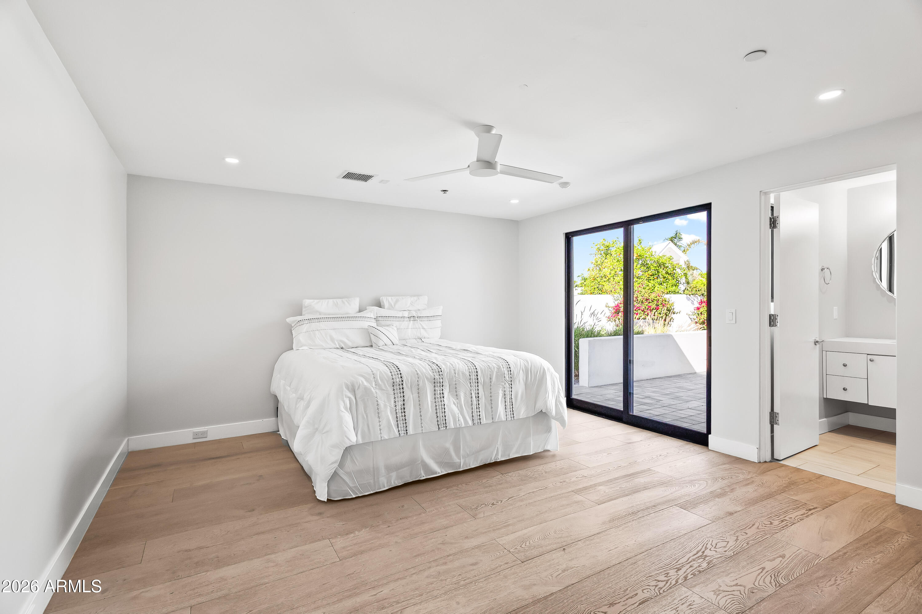 5430 North 41st Street Phoenix, AZ 85018 - Photo 20 of 38 a spacious bedroom with a large bed and a chandelier