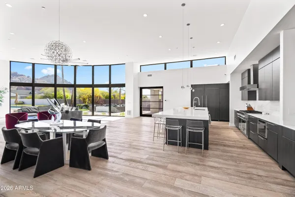 a large kitchen with a table and chairs