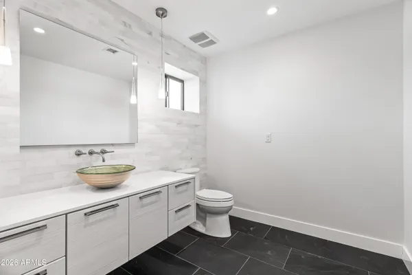 a bathroom with a toilet and a sink