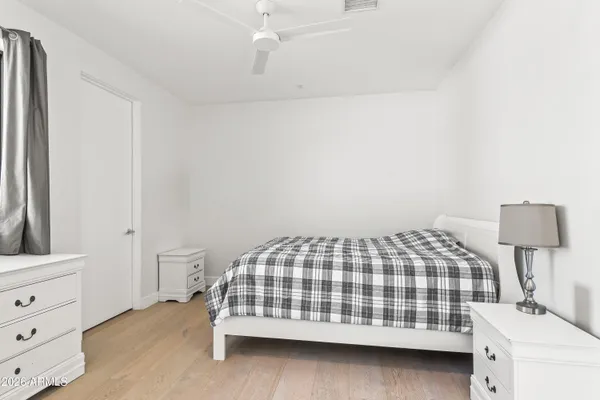 a bedroom with a bed and a night stand