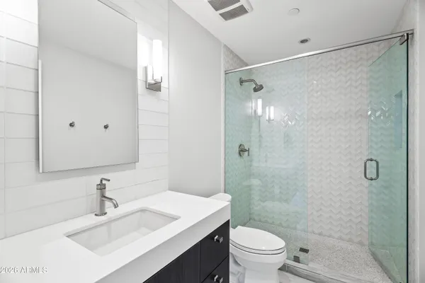 a bathroom with a sink toilet and shower