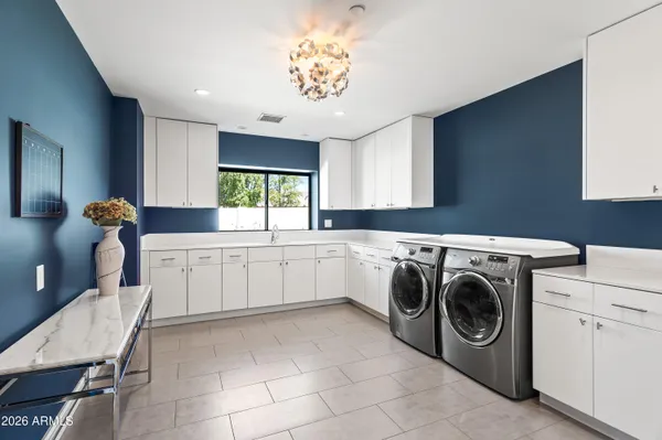 a utility room with cabinets dryer and washer