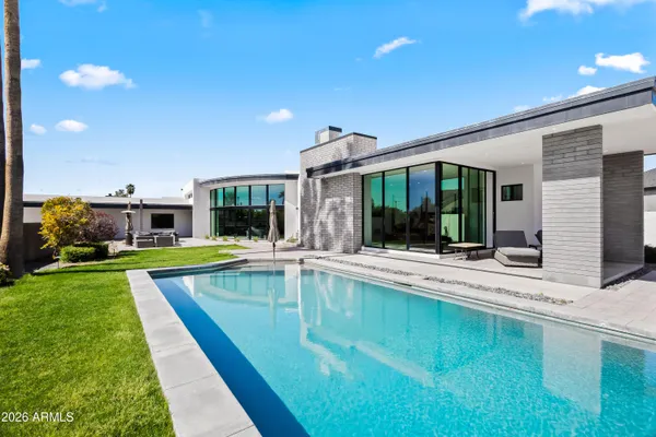 a view of a house with swimming pool and a yard