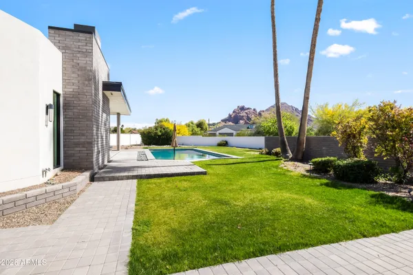 a view of a patio with a table and chairs