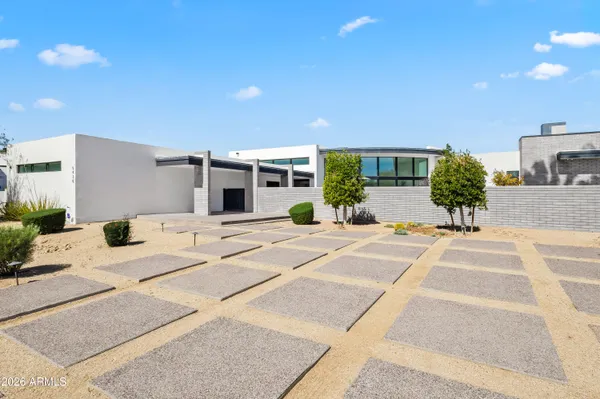 a view of a house with a backyard and a tree