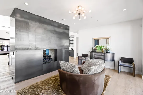 a living room with furniture and a chandelier